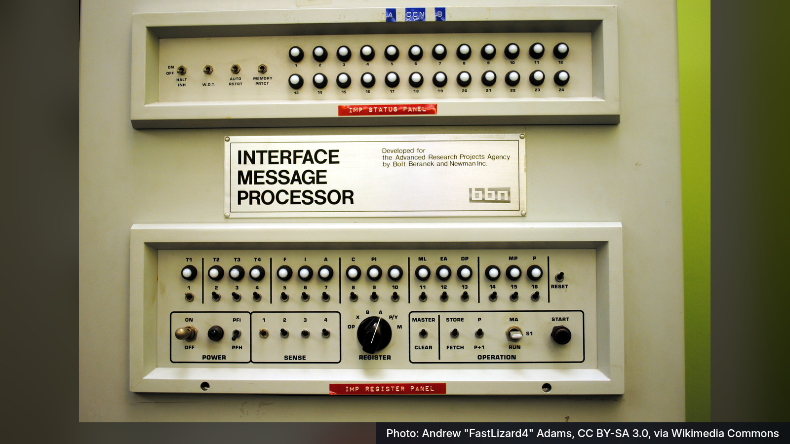 Photo: the front panel of the first Interface Message Processor at UCLA, a metal cabinet with two rows of small lights and switches under a plate that reads Interface Message Processor.