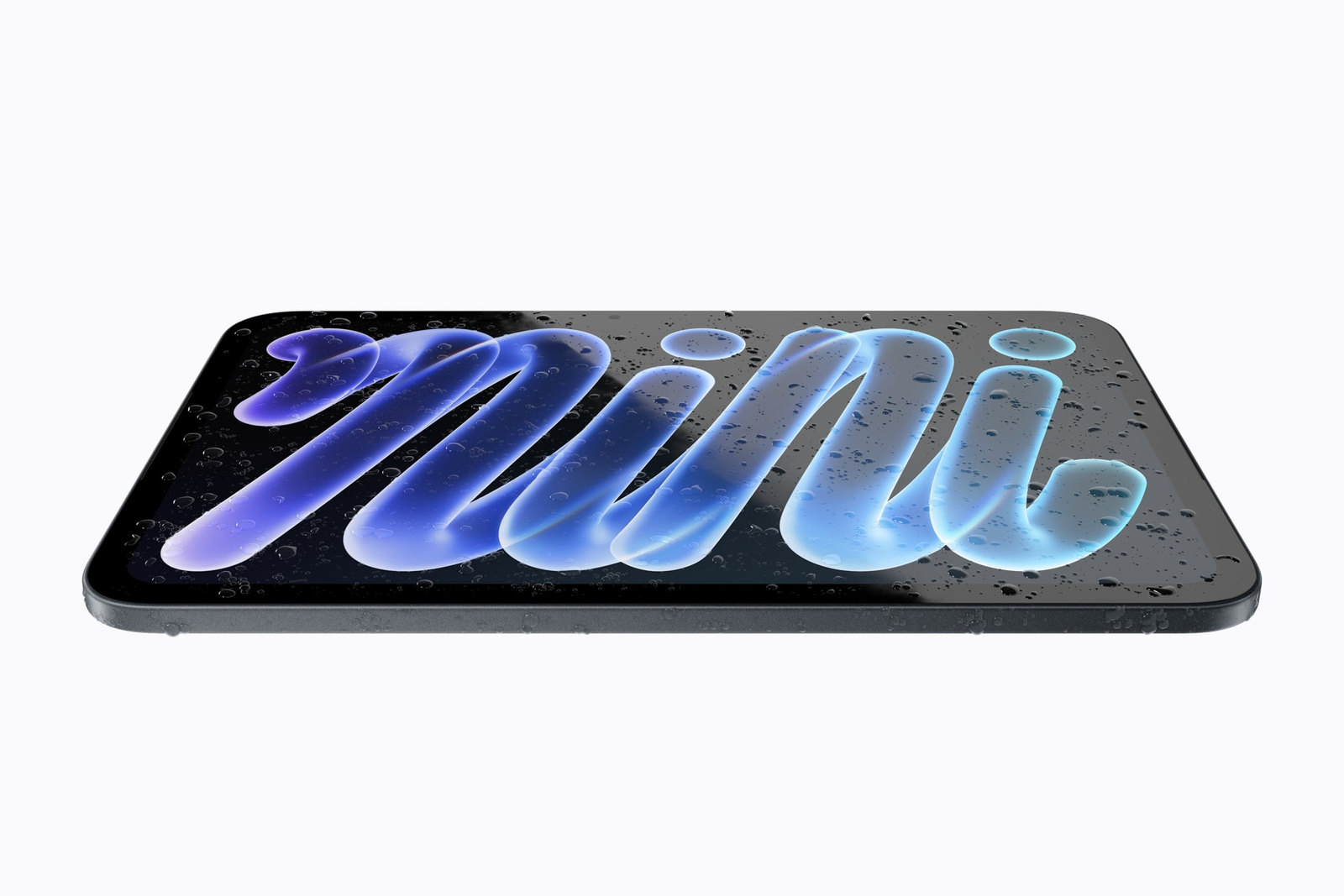 Photo: An iPad mini lying flat, covered in water drops, with the word mini on its screen.