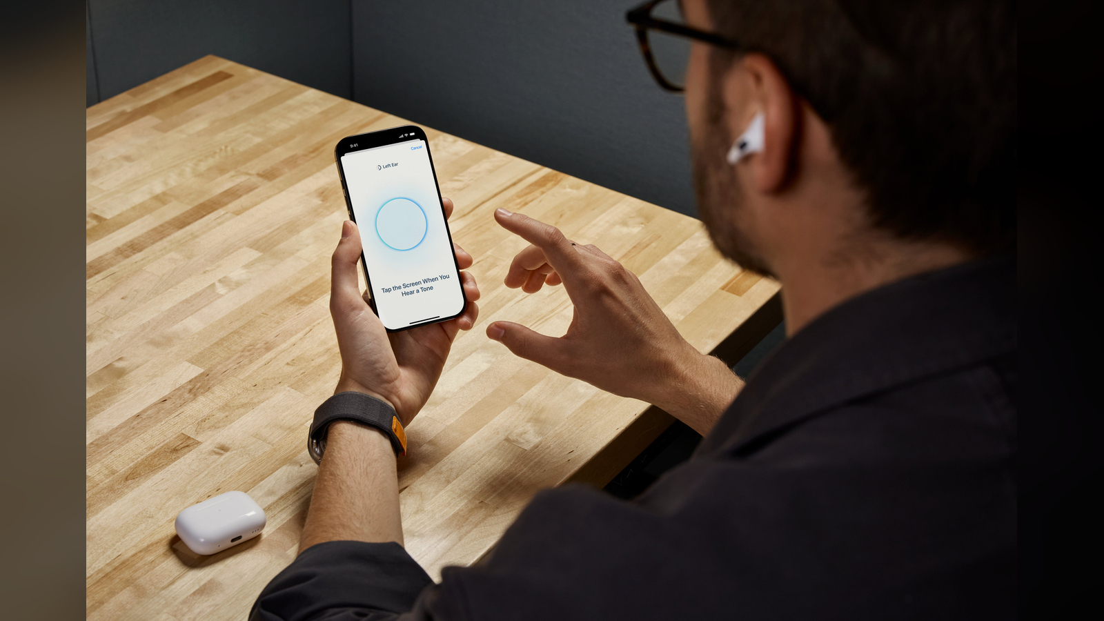 Photo: An iPhone shown with a pair of AirPods Pro.