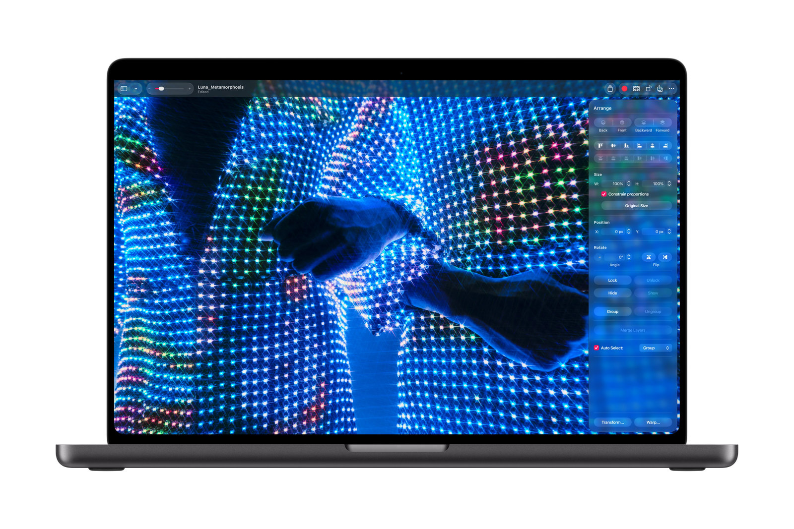 Photo: The MacBook Pro with PROLED XDR Display shows a colorful light-pattern image open in Pixelmator Pro.